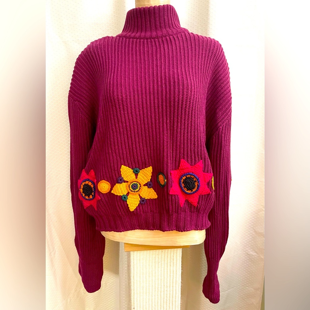 D. Exterior knit sweater with floral appliqué